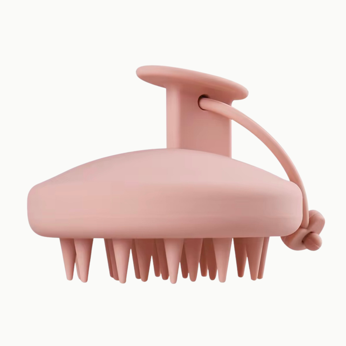 Salmon colored silicone scalp scrubber for hair growth, scalp exfoliation, and product buildup removal on white background.